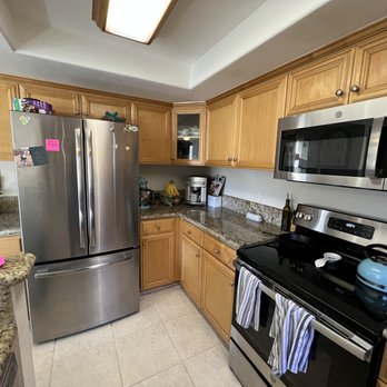 Refinished oak kitchen cabinets with stainless appliances